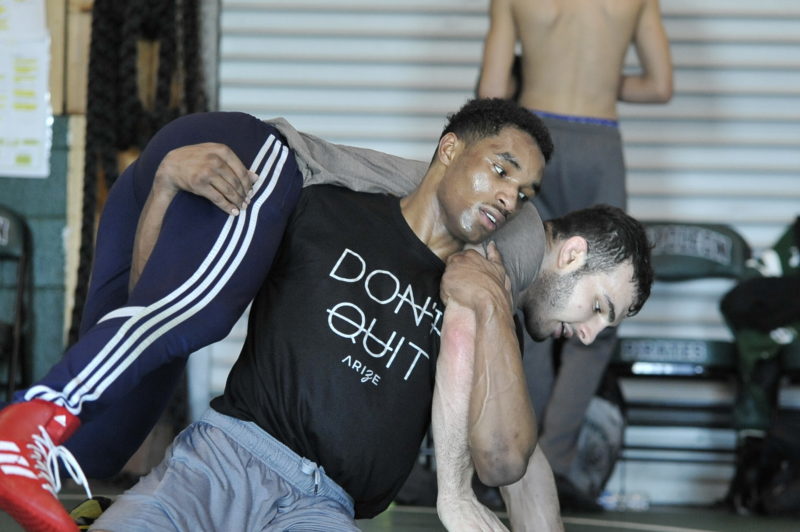 Ethan Weatherspoon, left, of Napoleon High School practices with Olympic hopeful and former University of Michigan wrestler Domenic Abounader during a recent practice.